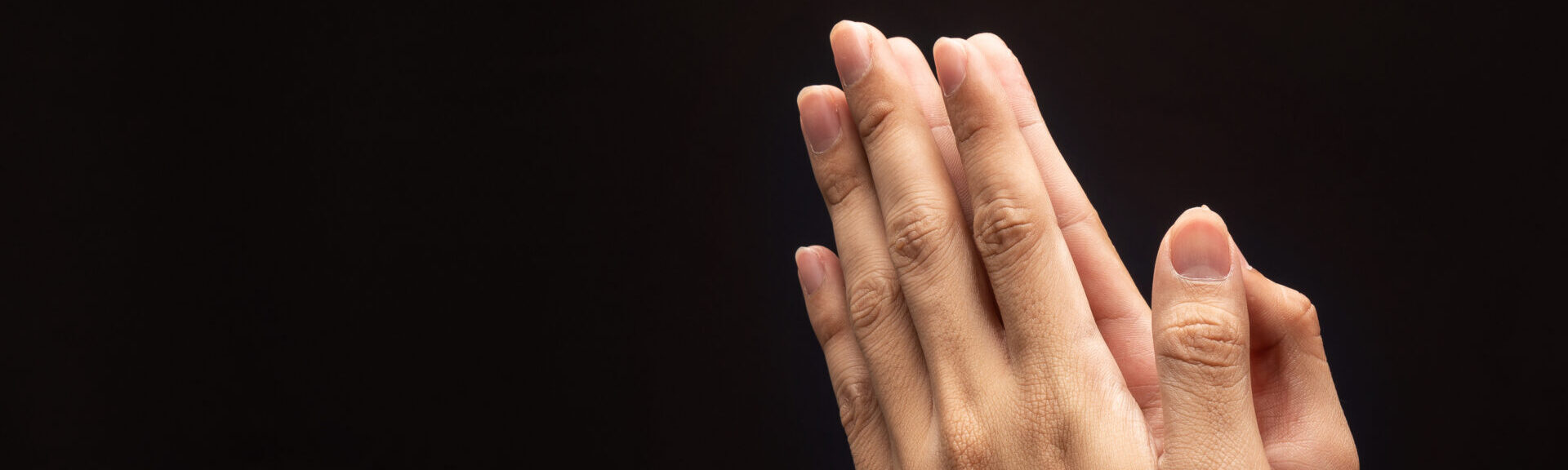 Praying Hands In The Dark Background With Faith In Religion And Belief In God